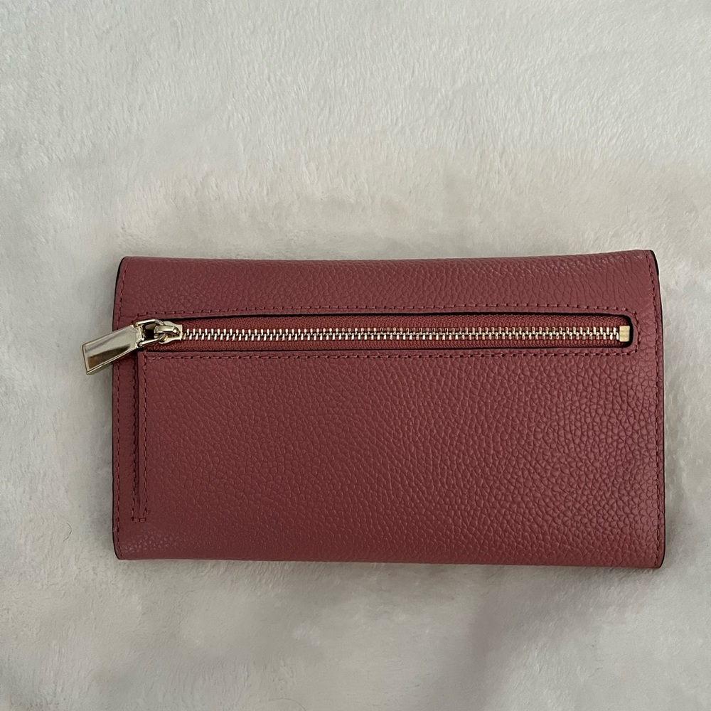 Michael Kors pink pebbled leather trifold wallet.